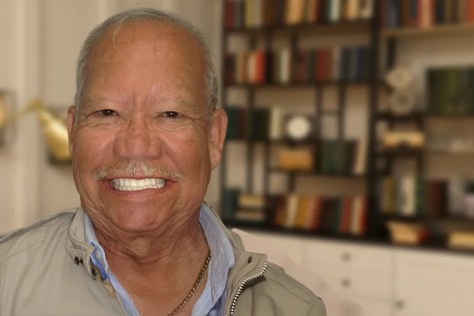 An older man smiling.